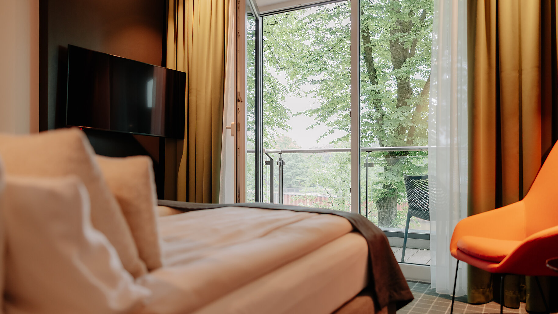 Modern eingerichtetes Doppelzimmer mit Balkon und Blick auf die Ems
